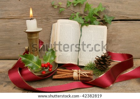 Christmas themed still life with a candle and prayer book