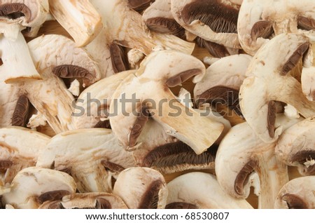 Sliced closed cup mushrooms as a background and texture