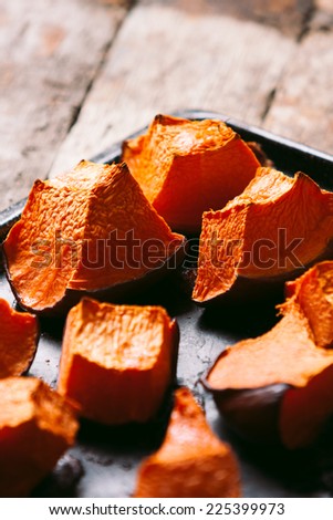 Tray of freshly roasted pumpkin. Low key lighting.