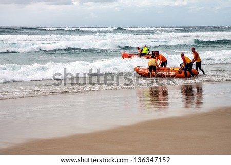 GOLD COAST, AUSTRALIA - AUGUST 12 2012 : Surf life savers training in the surf rescue boats near Broad beach on August, 12, 2012 in Gold Coast Australia.