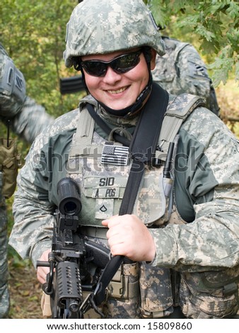 The portrait of the smiling US Army soldier with machine gun