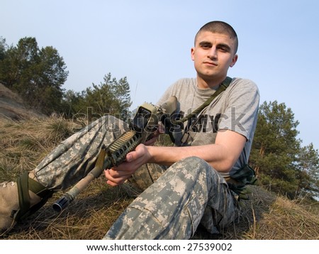 USA Soldier having rest on the grass at the end of the day after a hard training or combat