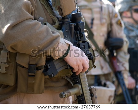 USA Special Forces soldiers - fully equipped man in desert uniform in front