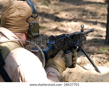 Machine Gun Operator in desert uniform on position