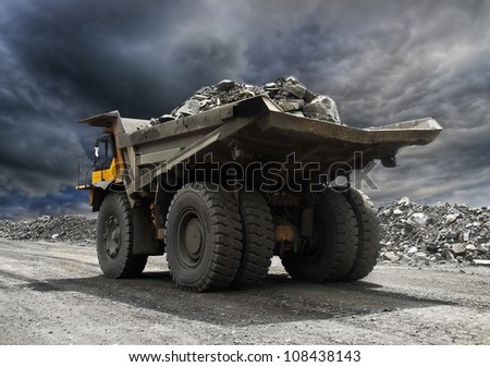 Heavy mining truck driving along the opencast