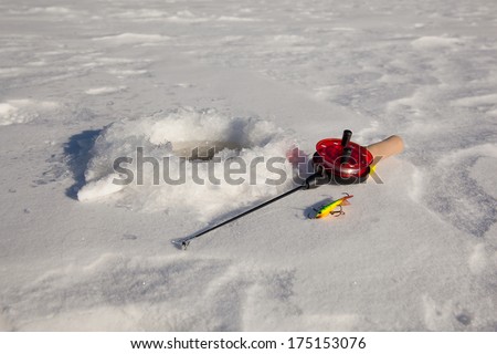 Ice fishing rod with the lure by the hole