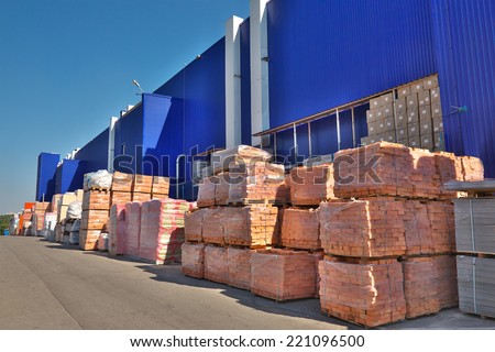 Construction materials stacked near the warehouse