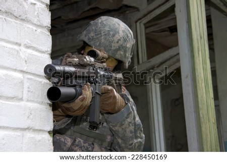 US Soldier on urban patrol mission aiming