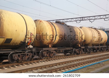 Cargo train with oil tanker cars carrying the fuel on the railway track