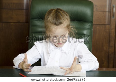 Preschooler girl writing in notebooks  of mathematics