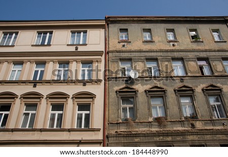 Contrast between old buildings one plaster is repaired and looks good and second is in bad condition.