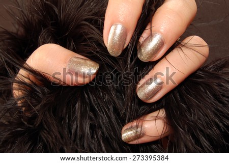 Female hand with nail polish holds fur.