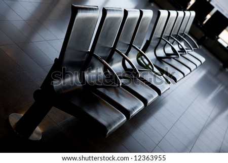 Comfortable row of black seats in an airport lobby