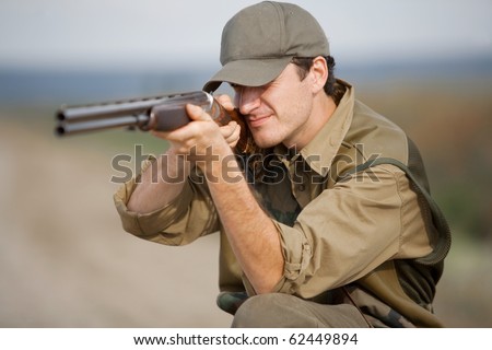 Young male hunter aiming the hunt during a hunting party