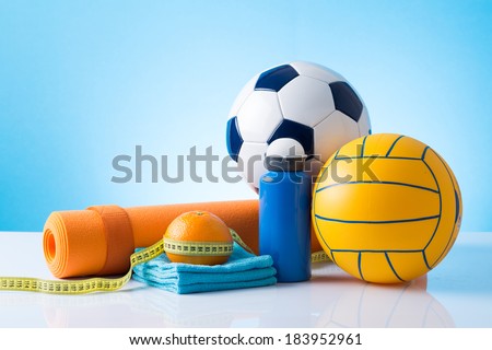 sport equipment, balls in front of blue background