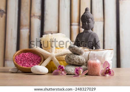 Aroma spa set with Buddha statue on bamboo background