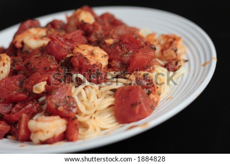 Close up of angel hair pasta with red sauce and shrimp