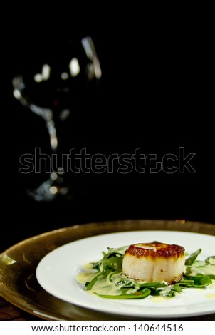 Chilean Sea Bass at the bottom right frame and an empty wine glass top left.