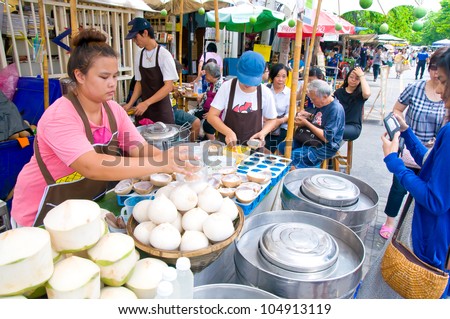 BANGKOK - JUNE 10: Street Coconut Juice vendor in a weekend bazaar on June 10, 2012 in Chatuchak Market, Bangkok Chatuchak Market is the world largest weekend market covering 27acre with 15,000 booths