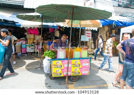 BANGKOK - JUNE 10:  Street Juice vendor in a weekend bazaar on June 10, 2012 in Chatuchak Market, Bangkok  Chatuchak Market is the world largest weekend market covering 27acre with 15,000 booths