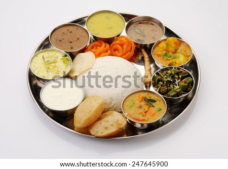 south Indian Thali served in marriages,vegetarian indian thali lunch,meals with rice, phulka(chapatti), puri(poori), curries, sambar, rasam, pulao, papad and sweets  Complete nutritional indian food