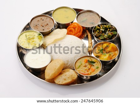 south Indian Thali served in marriages,vegetarian indian thali lunch,meals with rice, phulka(chapatti), puri(poori), curries, sambar, rasam, pulao, papad and sweets  Complete nutritional indian food