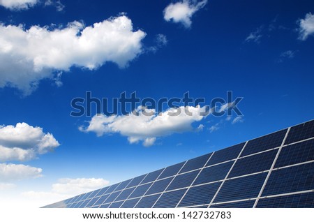 solar power station under blue sky, panels producing electricity