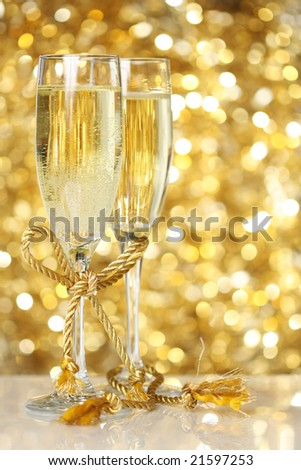 Champagne flutes with golden background