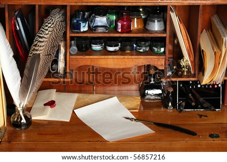 Old writing desk full of quills & inks for calligraphy