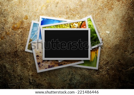 Pile of colorful photos with blank frame Pile of colorful photos with blank frame