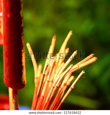 Red candle and incense for Chinese worship ceremony.