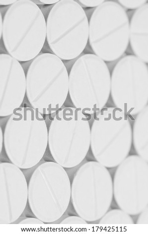 Pile of plain compress tablets, non-coated. Pharmaceutical products dosage form that easy to produce, carry and storage.