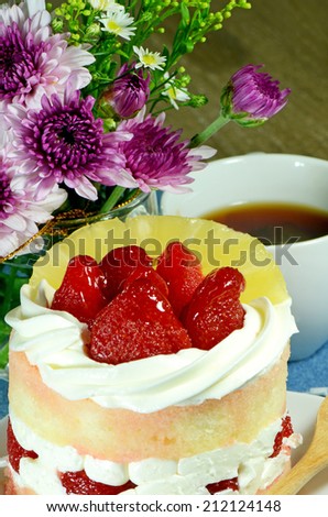 Strawberry short cake and tea decorated with purple Chrysanthemum flowers background.