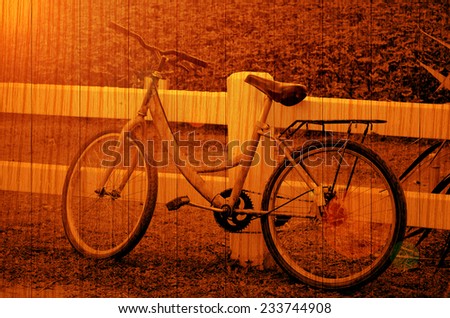 Old Bicycle with Evening Light on Wood Texture.