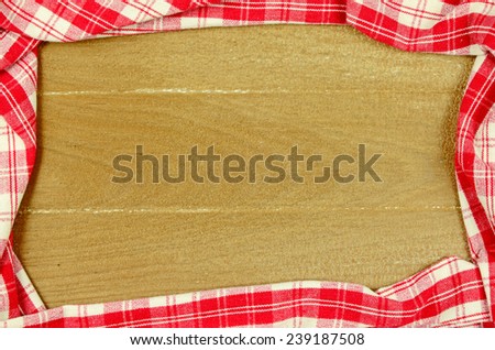 Red Table Cloth with Old Wooden Table Background.