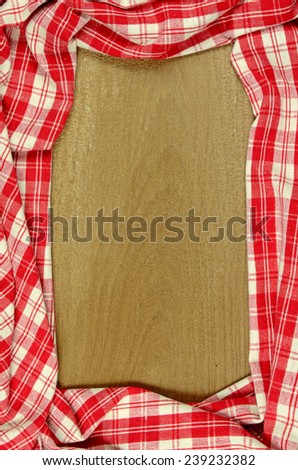 Red Table Cloth with Old Wooden Table Background.