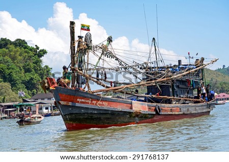 RANONG, THAILAND - APRIL 2, 2015: Myanmar fishing boat in Thai sea near Ranong fish market. Most of Myanmar fisherman sell their fish at Ranong fish maket.