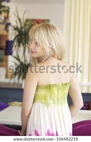 Portrait in profile of a beautiful romantic girl in summer dress