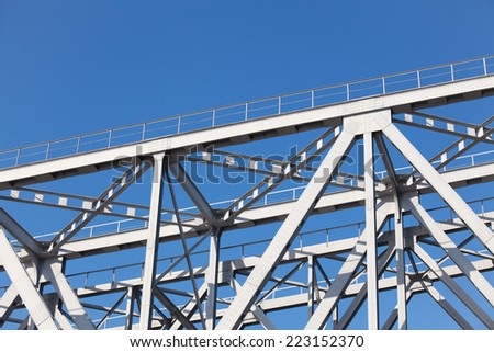 Steel structures truss bridge on background of blue sky
