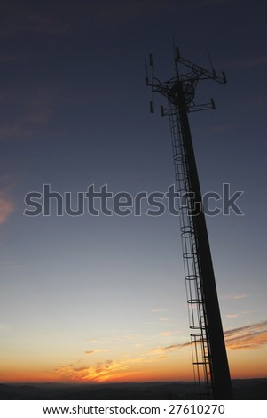 Telecommunications towers, relays and mobile radio antennas an sunset