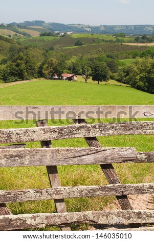 rustic wooden barrier un a green field