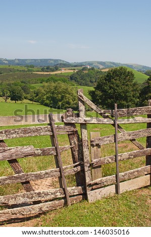 rustic wooden barrier un a green field
