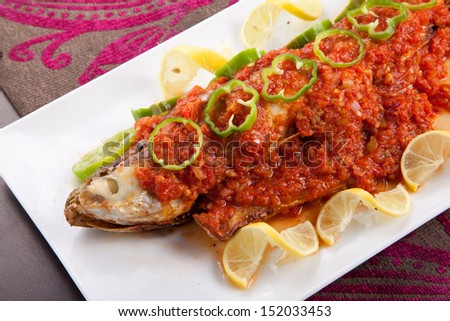 Fish with hot Sauce , lemon and pepper with rise