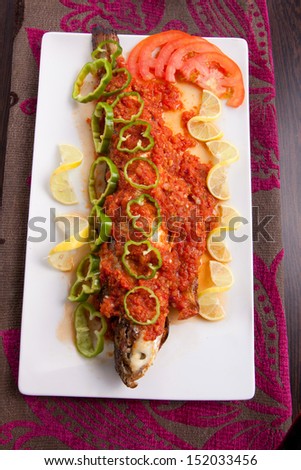 Fish with hot Sauce , lemon and pepper with rise
