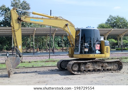 CHIANGMAI, THAILAND - NOVEMBER 15 2013: Private backhoe work for change railroad sleeper from wood to concrete. Work of State railway of thailand.  Photo at Chiangmai Train Station,  Thailand.