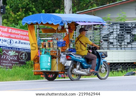 CHIANGMAI, THAILAND - SEPTEMBER 25 2014 : Vendor of Crepe cake  on a motorcycle. Photo at road no 121 about 8 km from downtown Chiangmai, thailand.