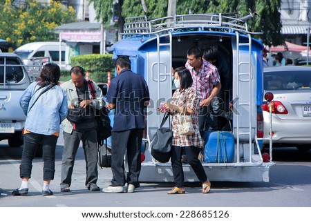 CHIANGMAI , THAILAND - OCTOBER 19 2014: Driver and Passenger of Pink mini truck taxi, Service between Chiangmai and Lamphun. Photo at New Chiangmai bus station, thailand.