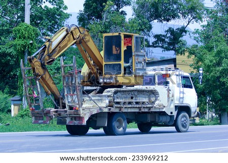 CHIANGMAI, THAILAND - MAY 9 2014:  Private truck and backhoe. Photo at road no.121 about 8 km from downtown Chiangmai, thailand.
