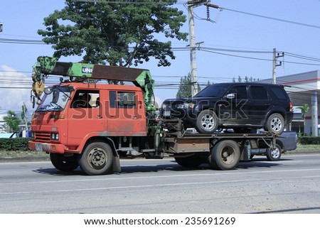 CHIANGMAI, THAILAND - OCTOBER 4 2014: Private Slide up tow truck for emergency car move. Photo at road no 121 about 8 km from downtown Chiangmai, thailand.