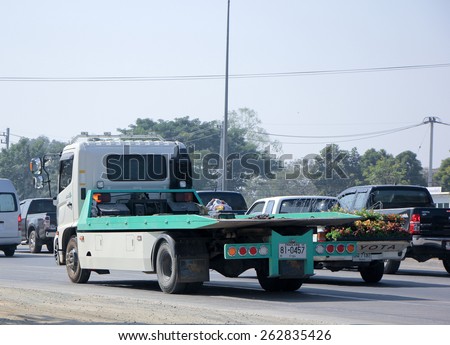 CHIANG MAI, THAILAND - MARCH 5 2015:  Private Slide up tow truck for emergency car move. Photo at road no.1001 about 8 km from downtown Chiangmai, thailand.